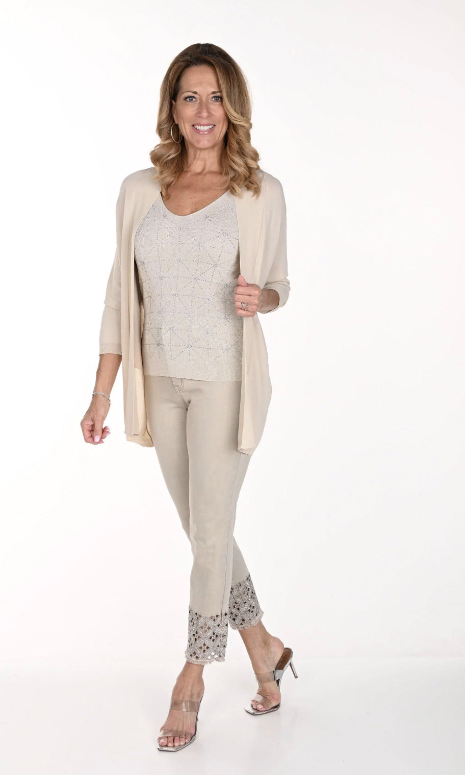 Woman wearing the beige jeans with embroidered detail around ankle by Frank Lyman, sold and shipped from Pizazz Boutique