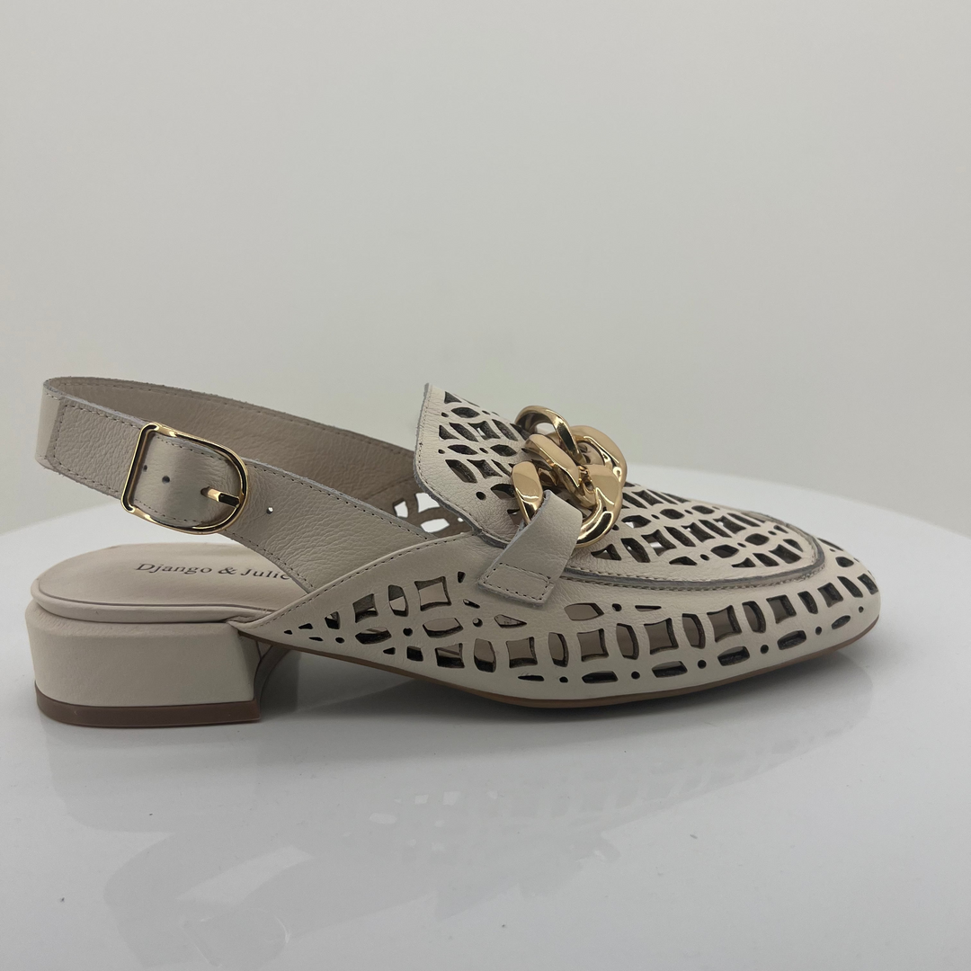 Ivory sandal with cut-out design and gold buckle on a white background