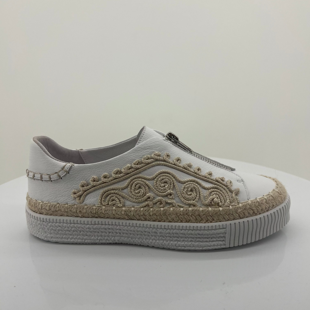 White sneaker with decorative patterns on a white background