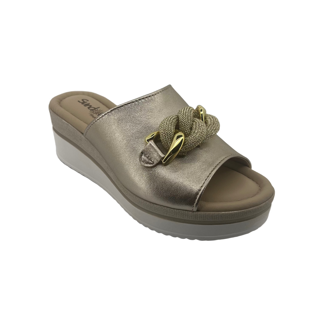 Gold sandal with a platform sole on a white background