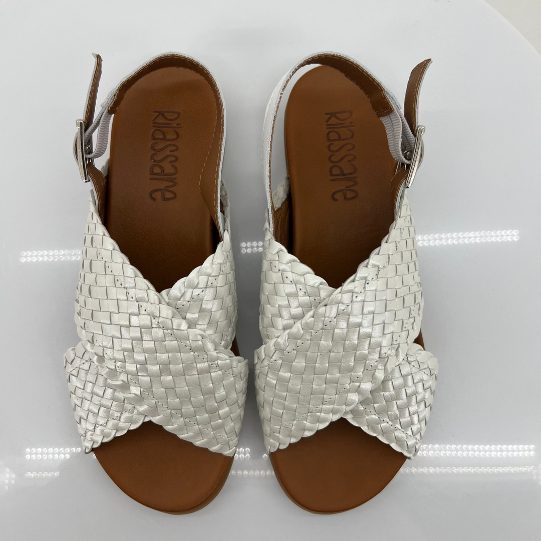 Pair of white woven sandals on a white background