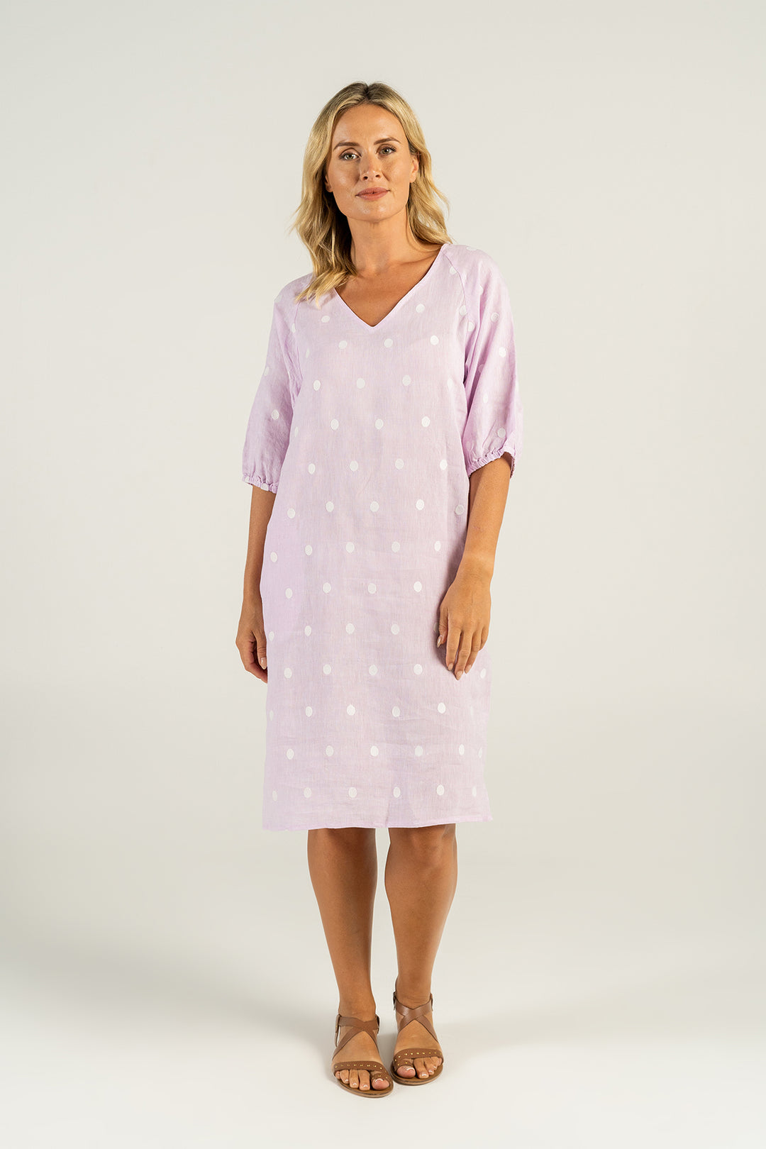 Woman wearing a pink linen dress with white spots by See Saw clothing, sold and shipped from Pizazz Boutique Nelson Bay online women's clothes shops Australia
