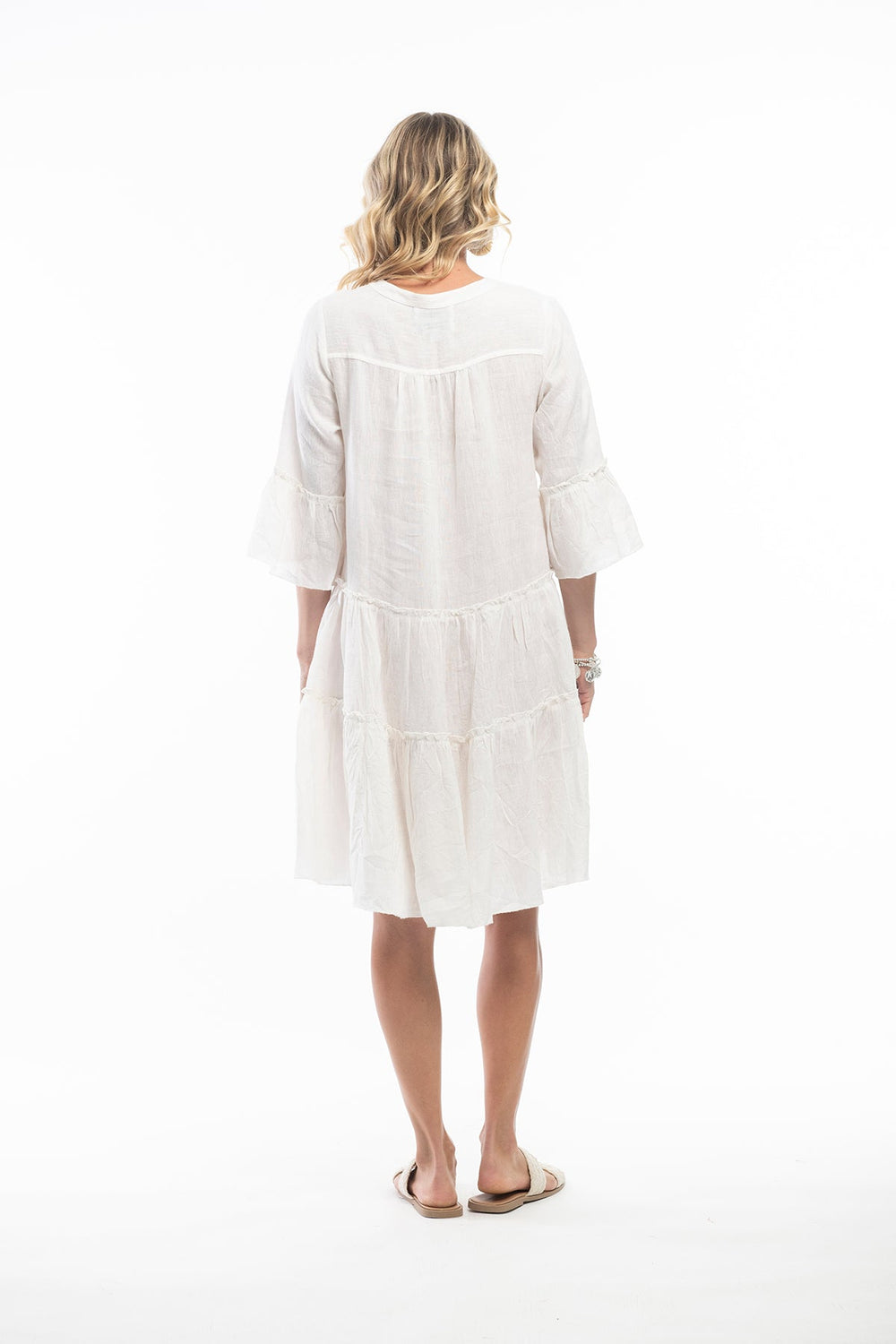 Woman wearing a cream linen dress by escape Sold and shipped from pizazz Nelson Bay, women's dresses online Australia