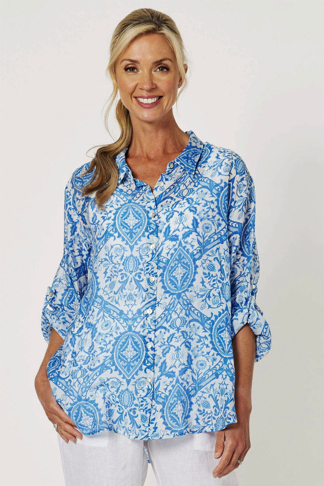 woman wearing a Gordon Smith blue and white resort shirt from Pizazz Boutique