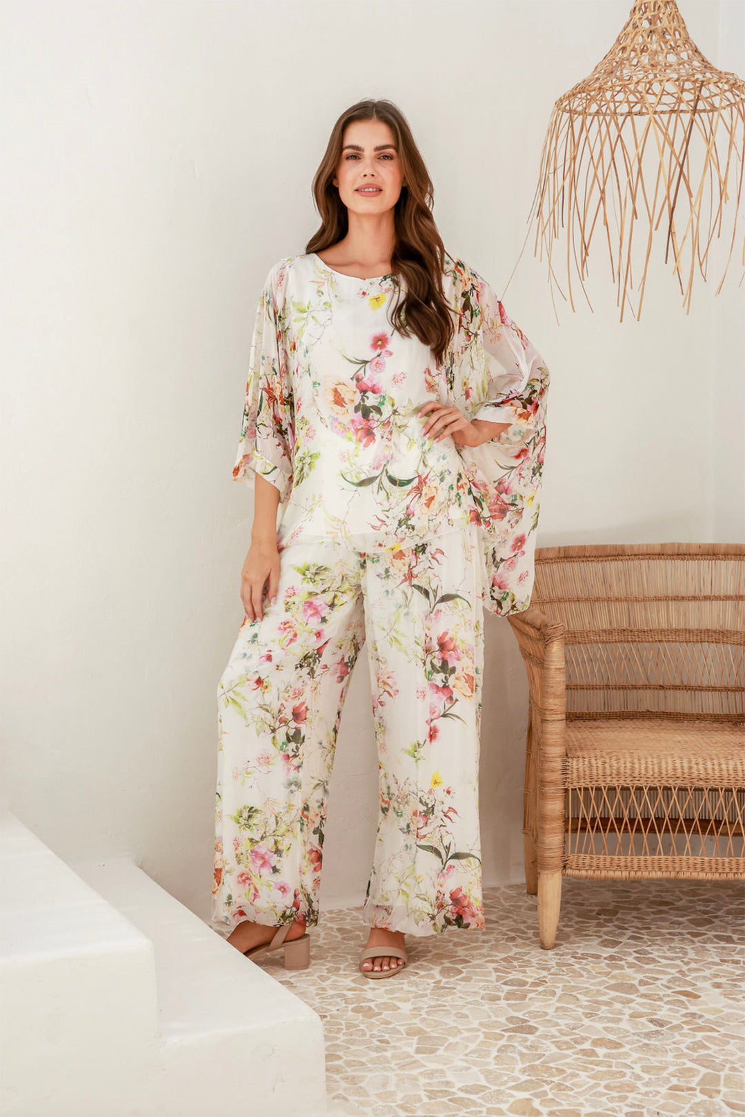 Woman wearing a floral top and pant set by The Italian Cartel, sold and shipped from Pizazz Boutique online women's clothes shops Australia front view