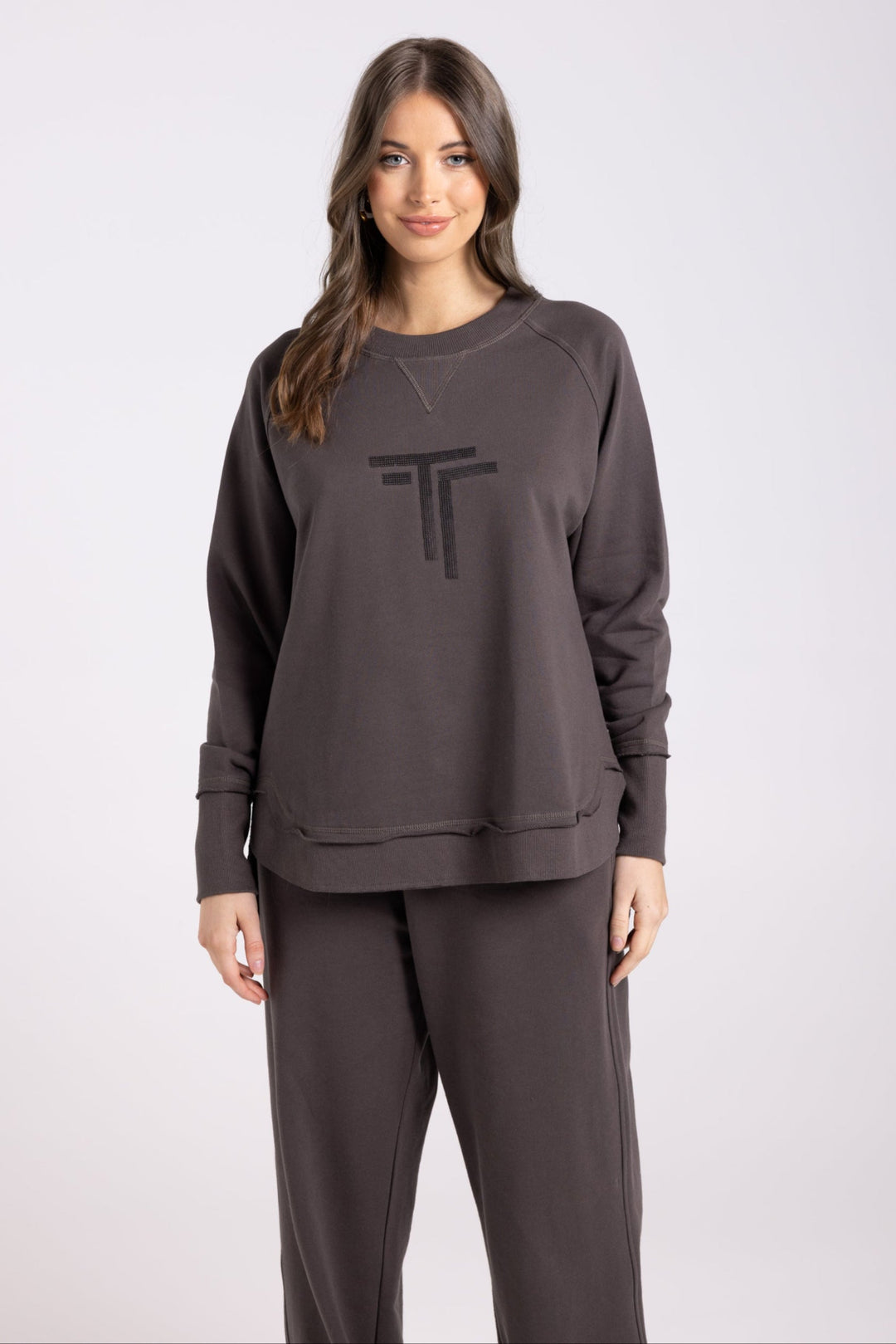Lady wearing Sequinned Sweat in Espresso brown colour with two tS on the front