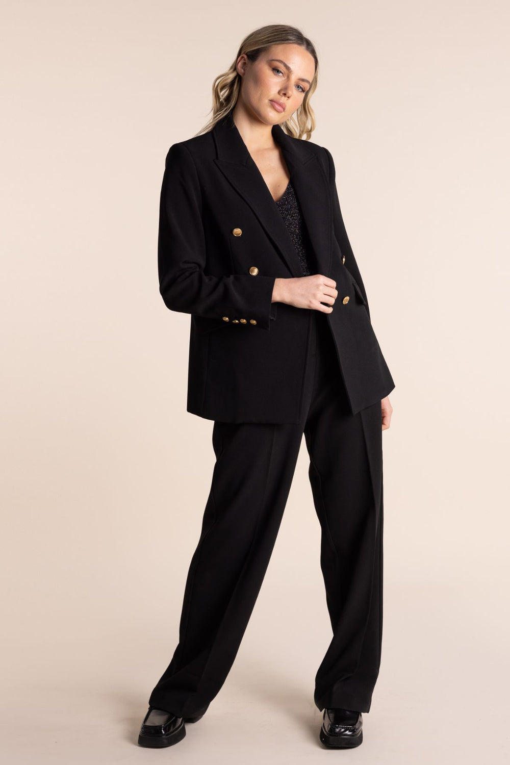The Trinity Blazer by designer Two T's is a lux wardrobe staple. This classic blazer is comfortable and stylish. Featuring gold buttons, two front faux pockets and a classic lapel.   Brand : Two T's  Style code : 2555 Colour : 2555 Fabric : Main - 96% Polyester 4% Elastane  Lining - 97% Polyester 3% Elastane Dry clean recommended or hand wash  Lined