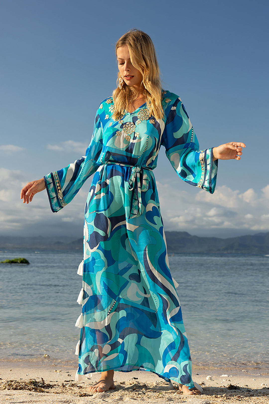 Woman wearing a blue dress on a beach from Pizazz Boutique Nelson Bay