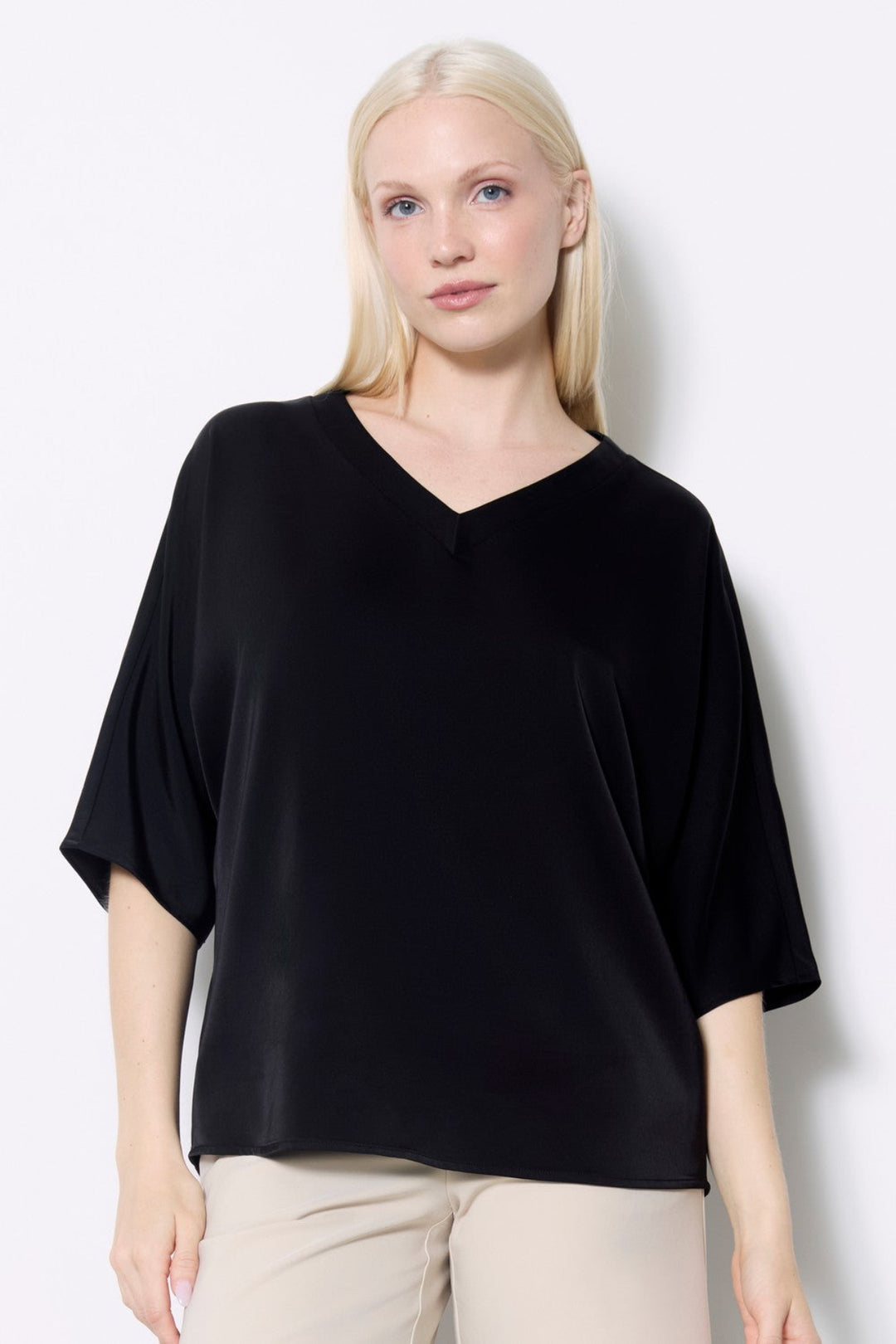 Woman wearing a black top against a white background