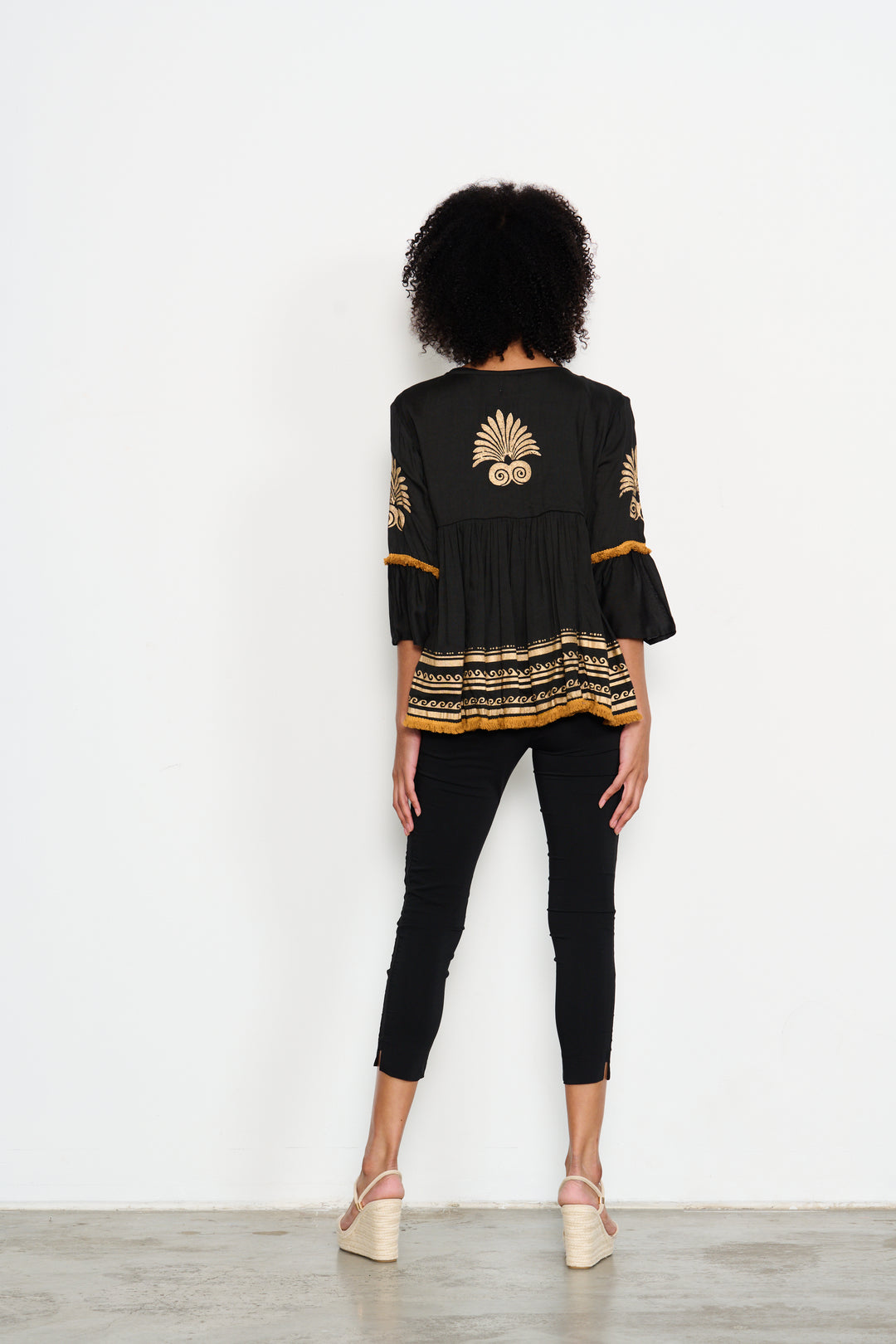 woman standing front view with black and gold jacket by Caju from Pizazz Boutique Nelson Bay
