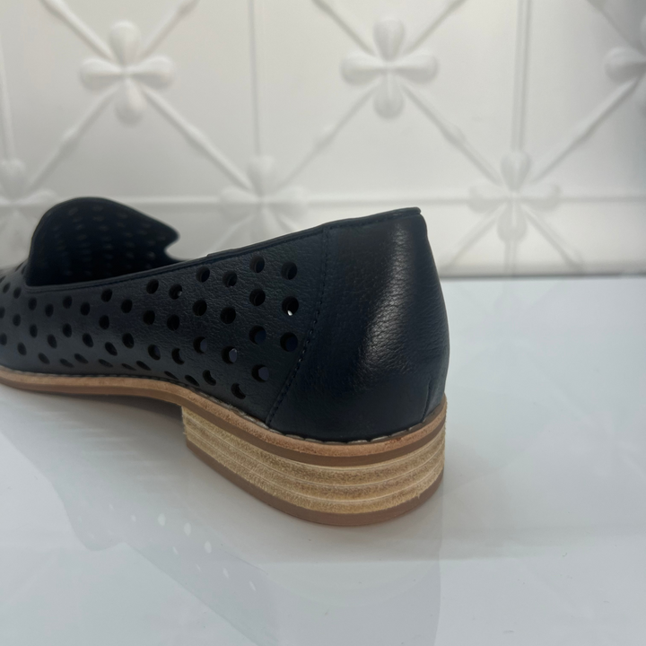 Navy perforated shoe with a wooden sole on a white background