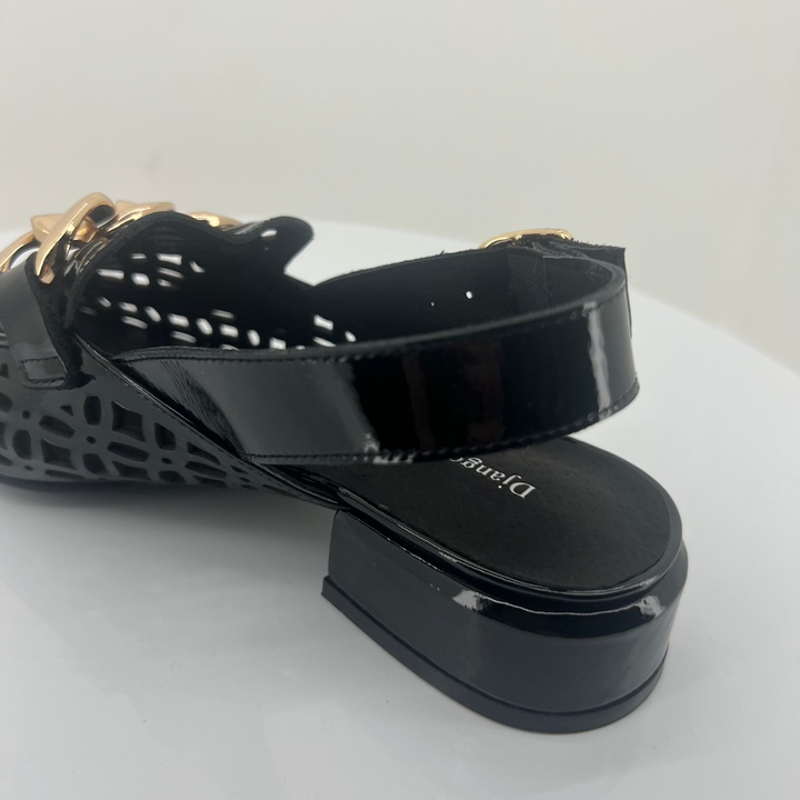 Black sandal with open-toe design on a white background