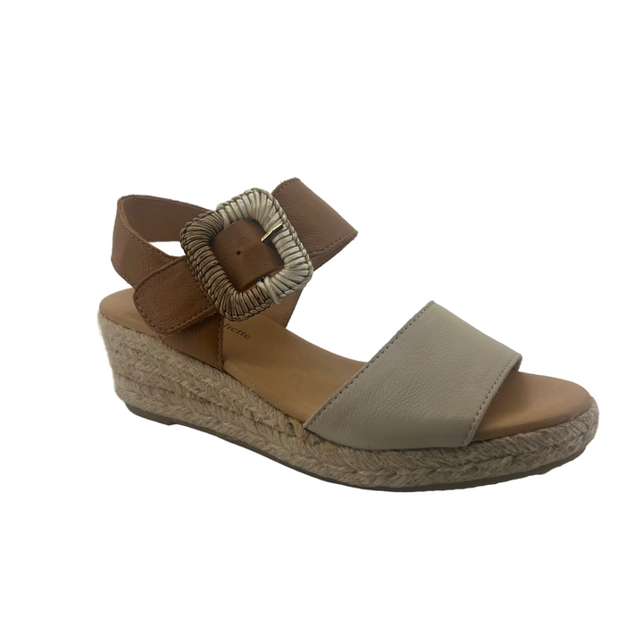 Brown wedge sandal with a buckle on a white background