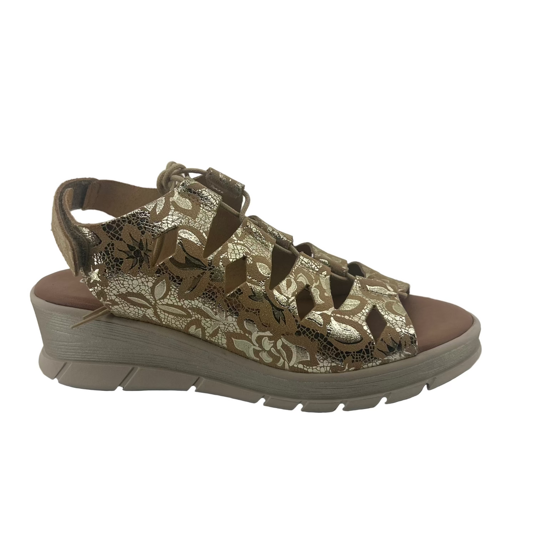 Gold patterned sandal on a white background