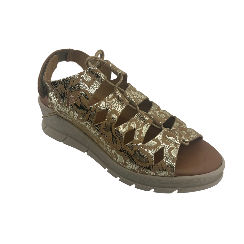 Brown sandal with decorative pattern on a white background