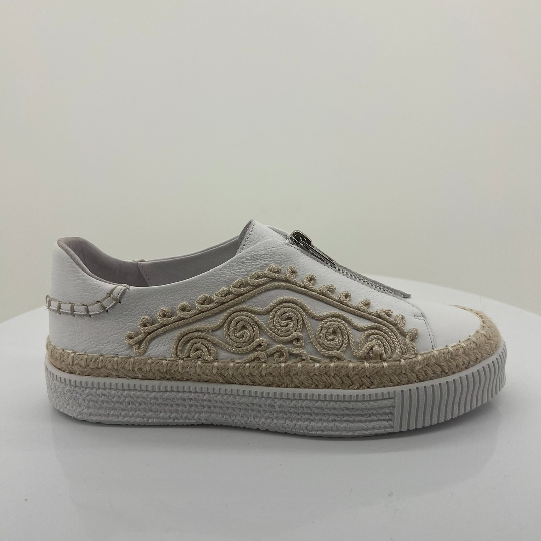 White sneaker with decorative patterns on a white background