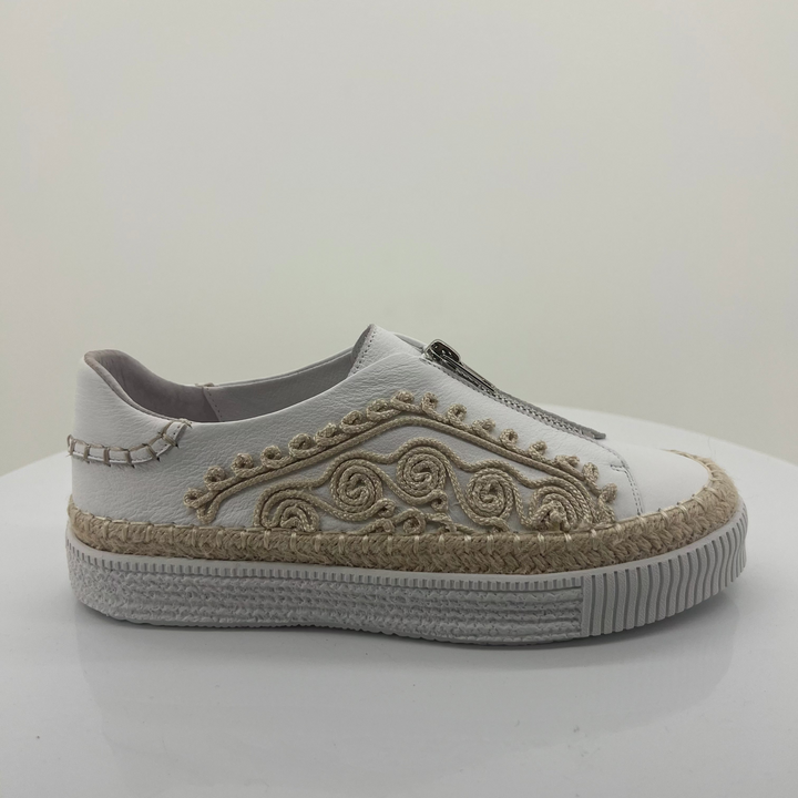 White sneaker with decorative patterns on a white background