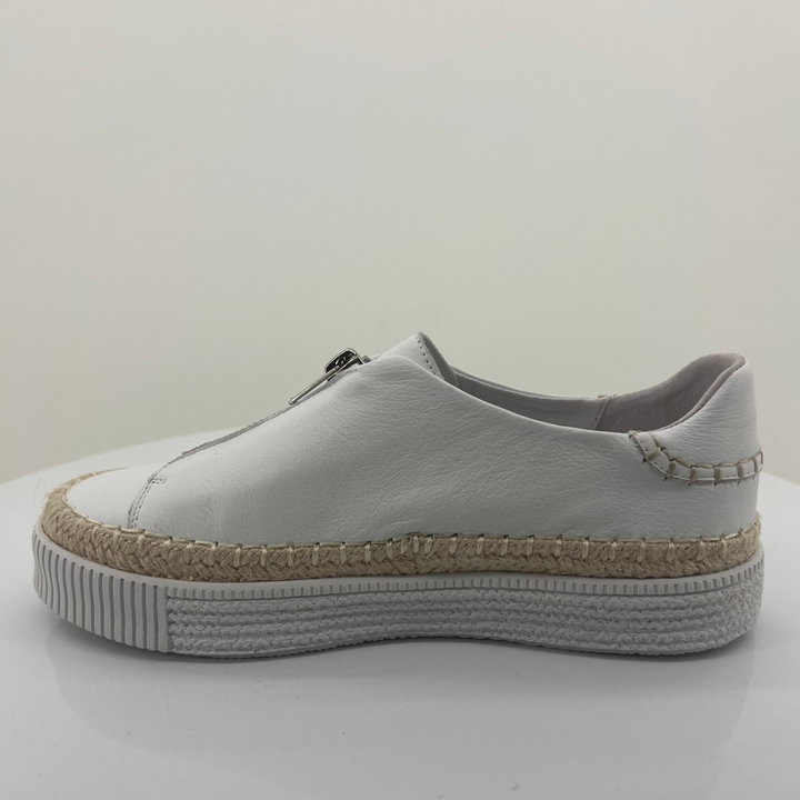 White sneaker with a textured sole on a white background
