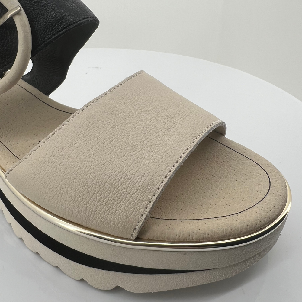 Beige sandal with a platform sole on a white background