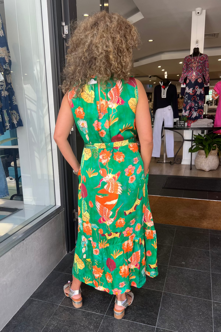 Person wearing a colorful floral dress in a store setting