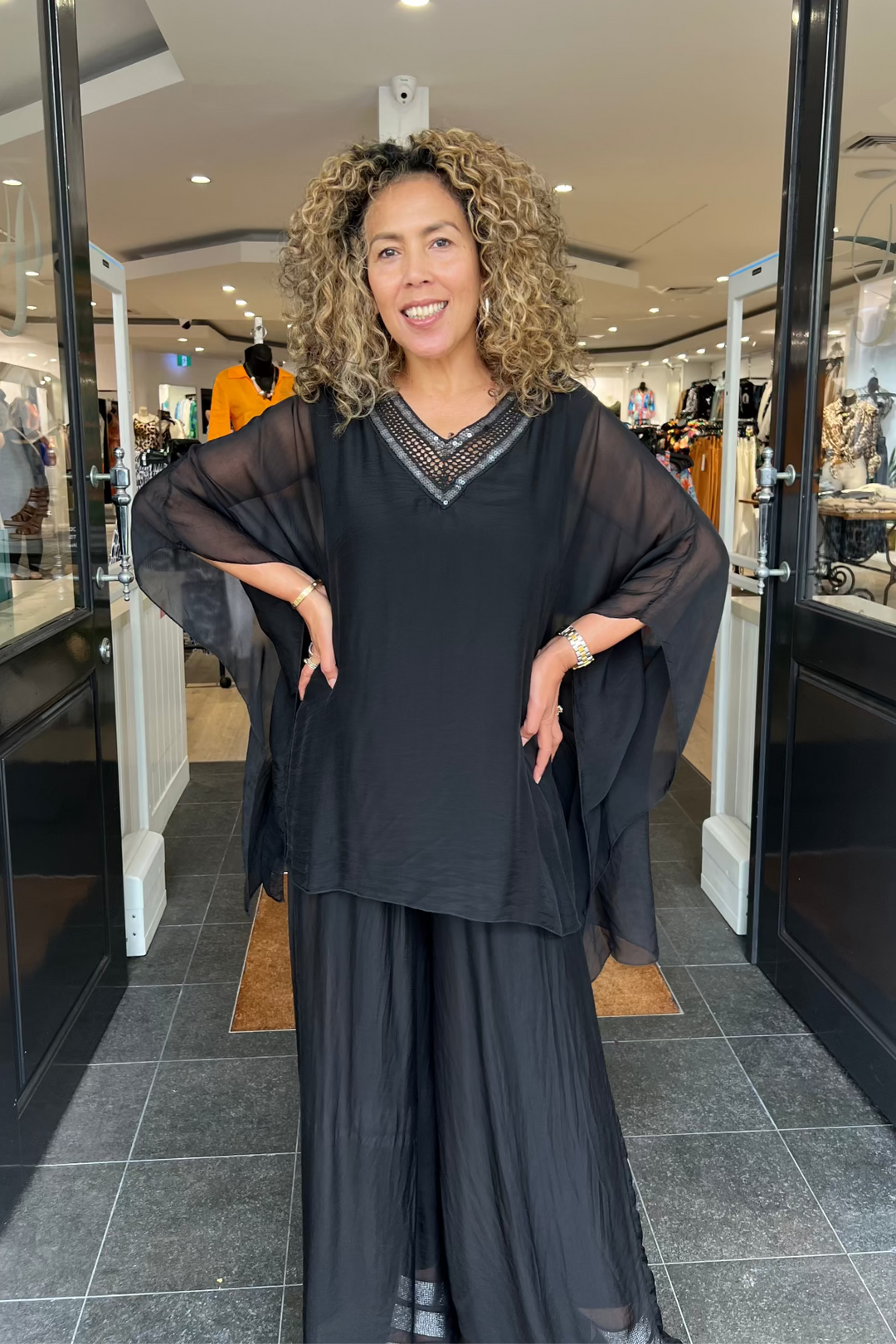 Woman in a black outfit standing in a store