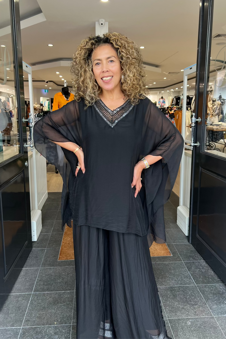 Woman in a black outfit standing in a store
