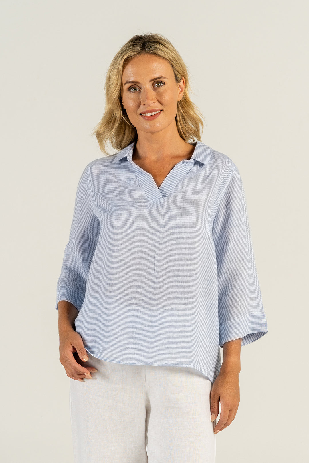 woman wearing a 100% linen top with blue and white stripes by See Saw clothing, sold and shipped from Pizazz Boutique Nelson Bay online women's clothes shops Australia back view