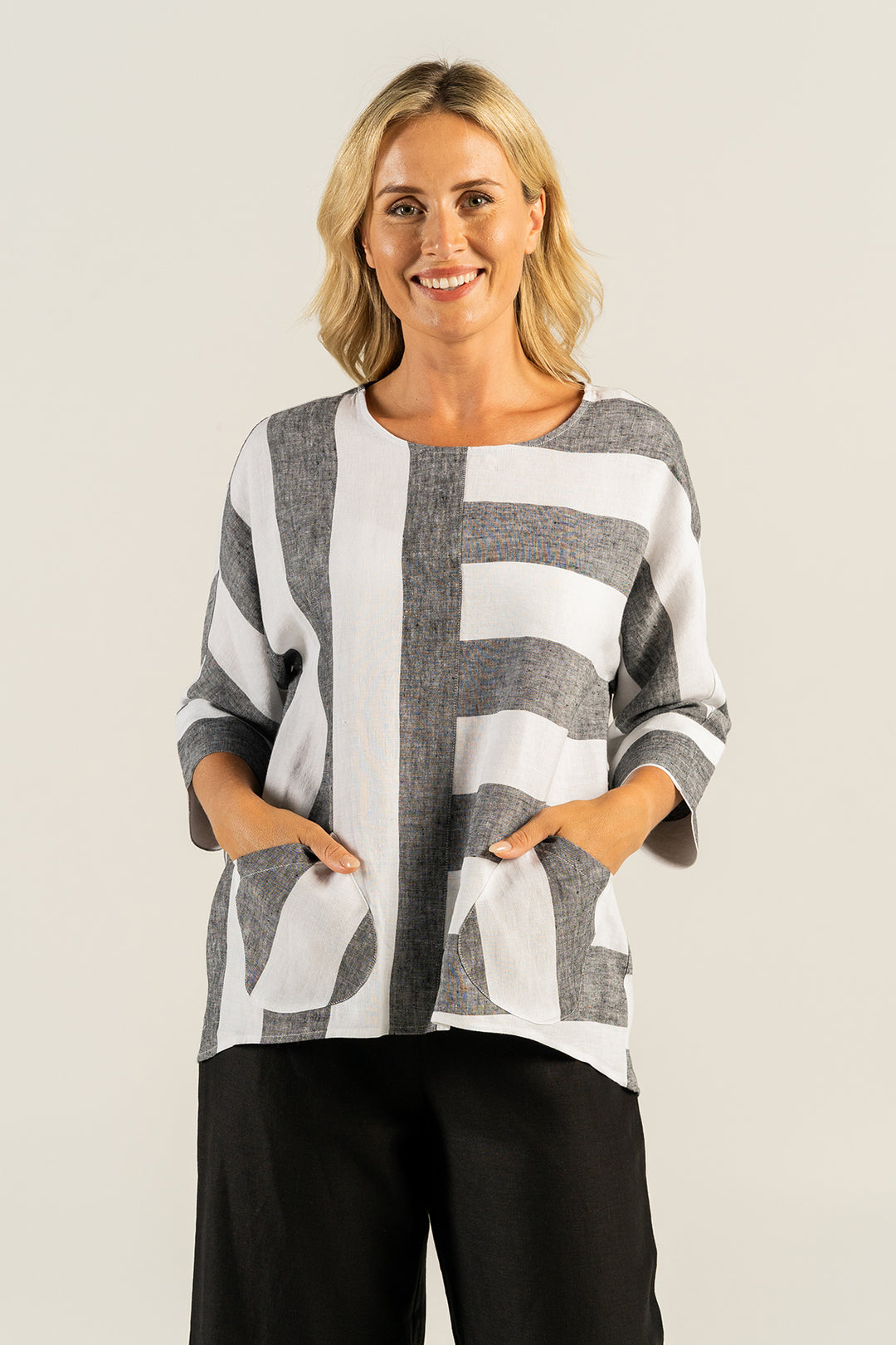 Woman wearing a white and grey linen top by See Saw clothing, sold and shipped from Pizazz Boutique Nelson Bay online women's clothes shops Australia