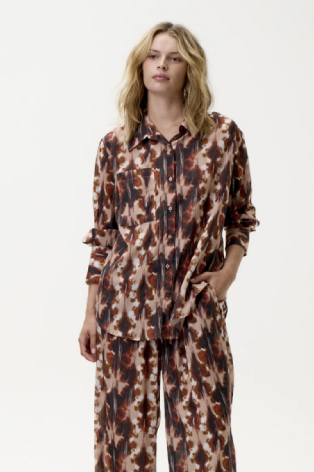 Person wearing a patterned outfit on a white background