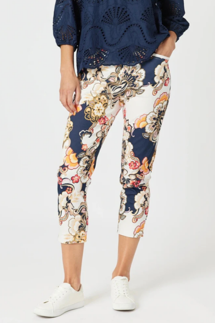 Person wearing floral-patterned pants on a white background