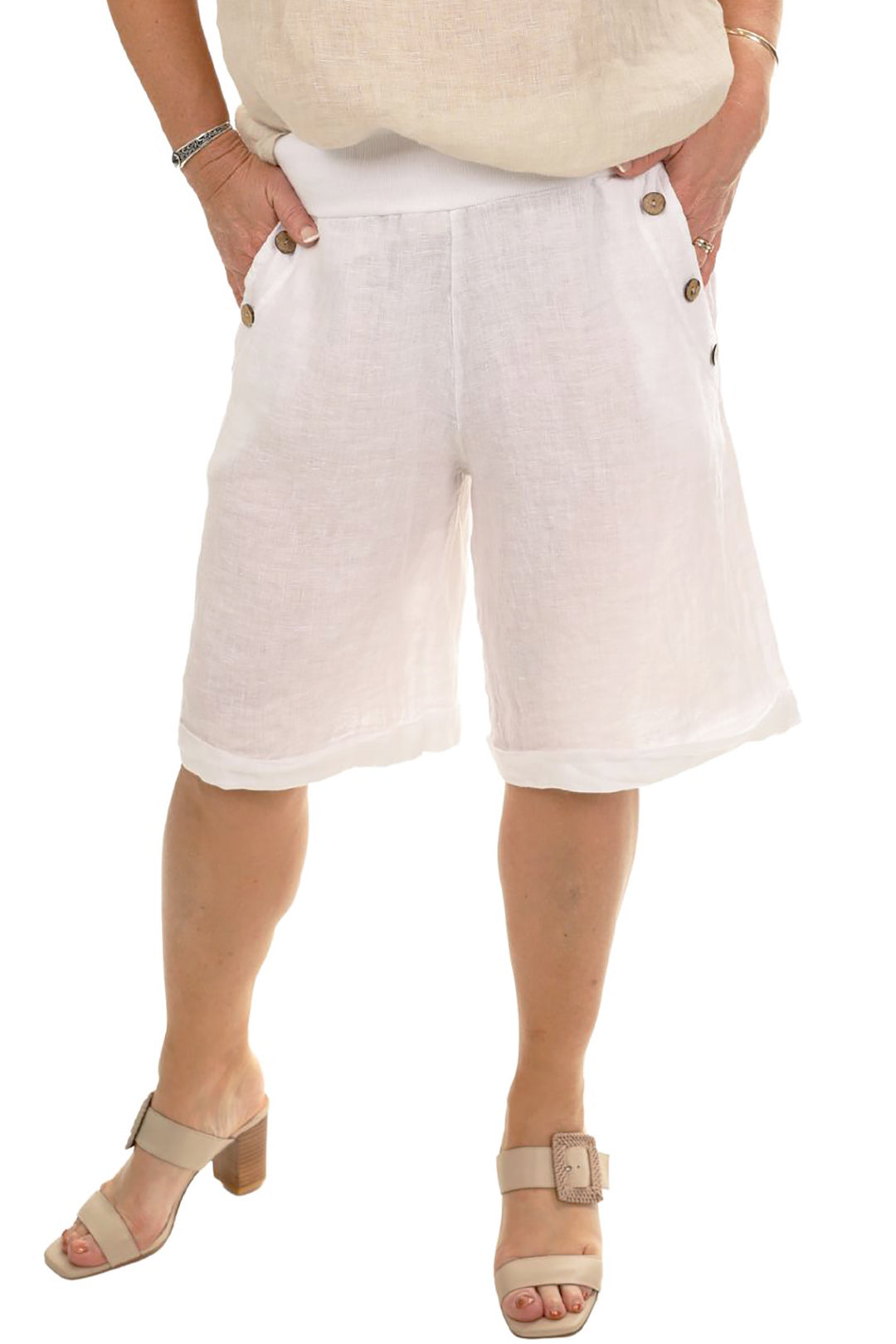 Person wearing shorts with their hands in their pocket front view in a white colour and flats white from Pizazz Boutique Nelson Bay dress shops