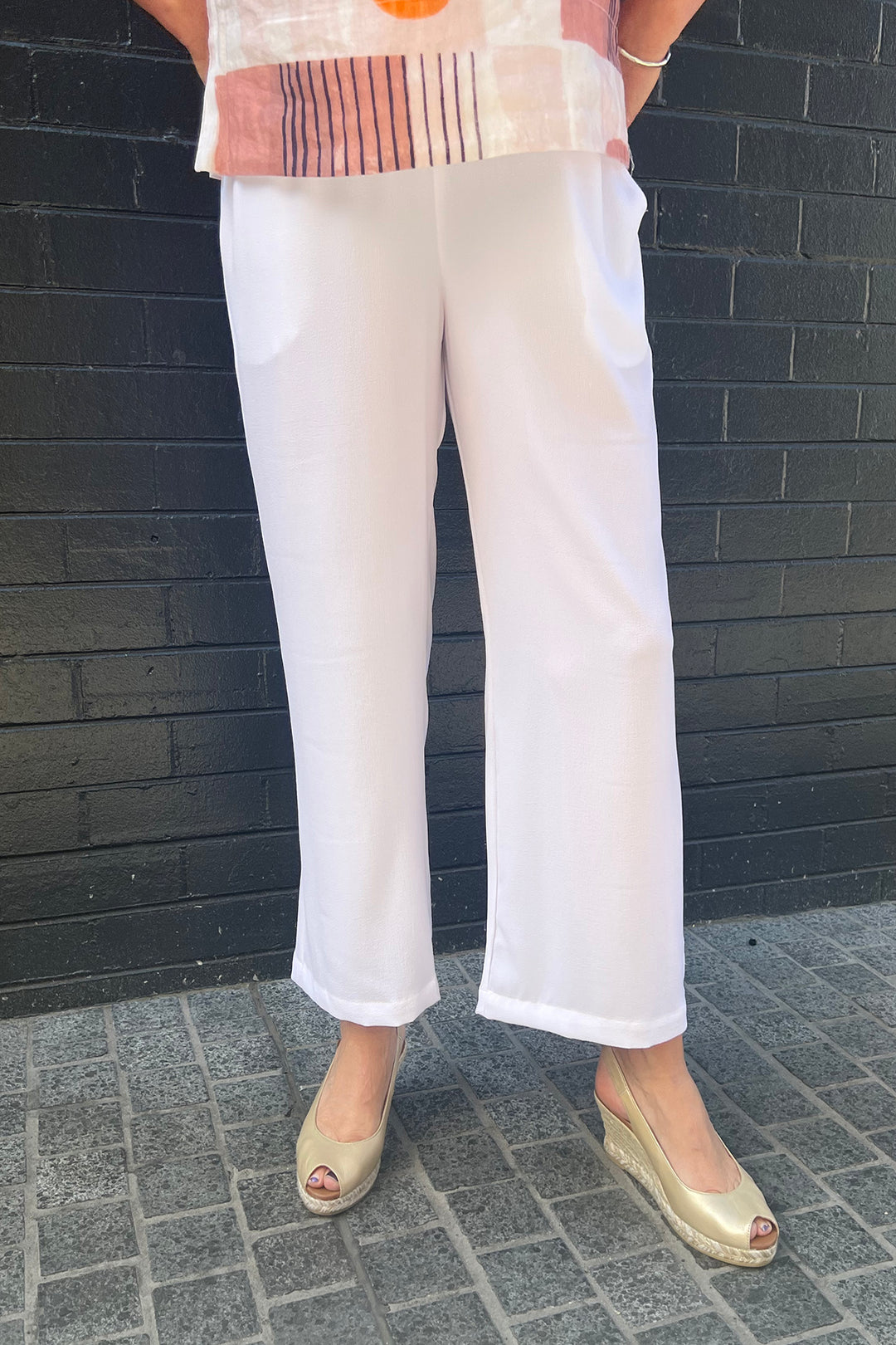 Woman wearing the Aubery flare pant in white b Philosophy, sold and shipped from Pizazz Boutique Nelson Bay women's dresses online Australia