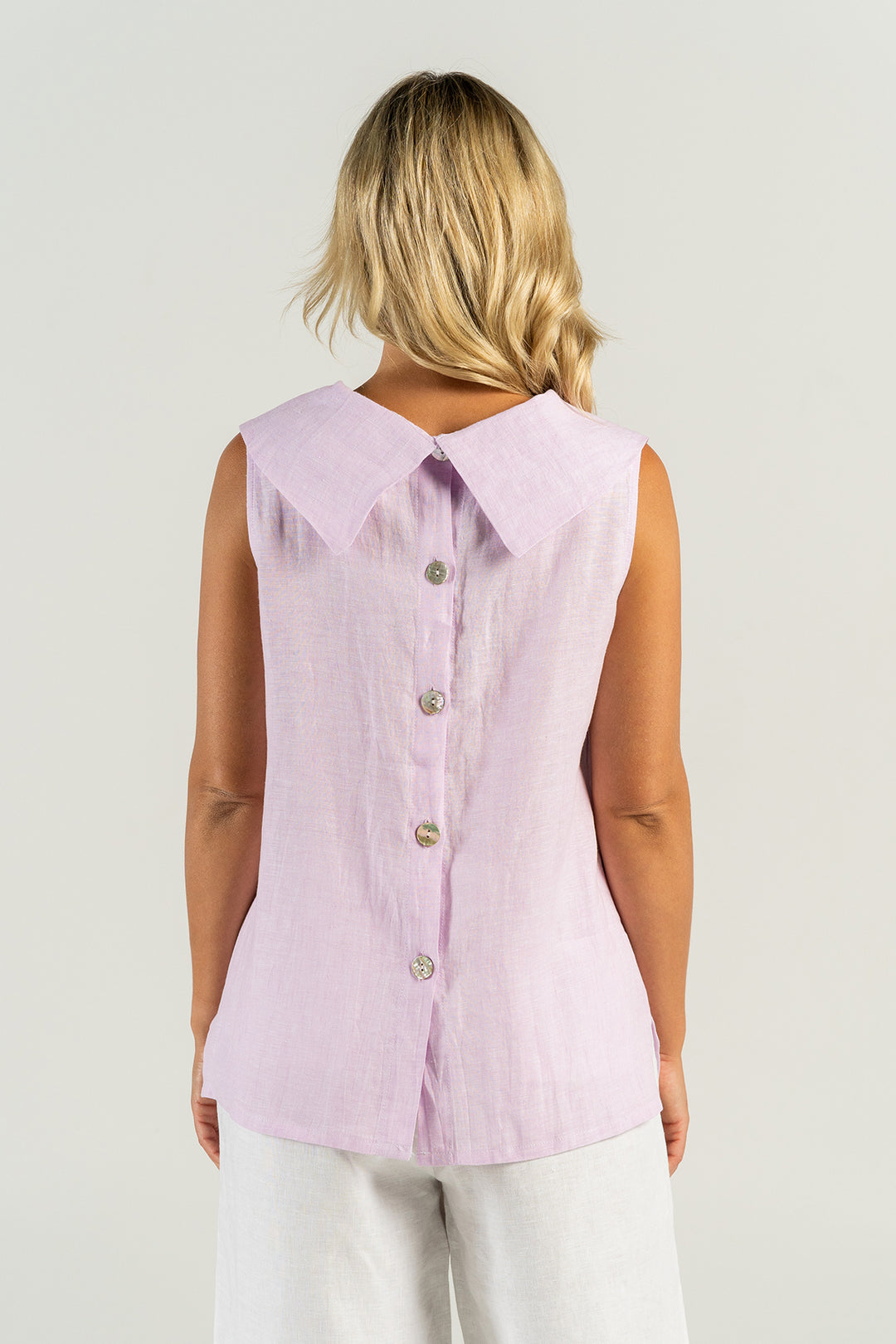 Woman wearing a cowl neck top in pink lilly by See Saw clothing, sold and shipped from Pizazz Boutique Nelson Bay online women's clothes shops Australia back view