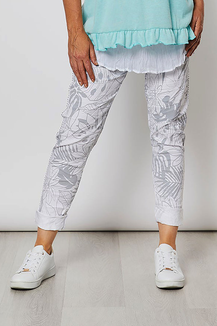 Woman wearing white jeans with a silver patters on them by Threads, sold and shipped from Pizazz Boutique online women's clothes shops Australia