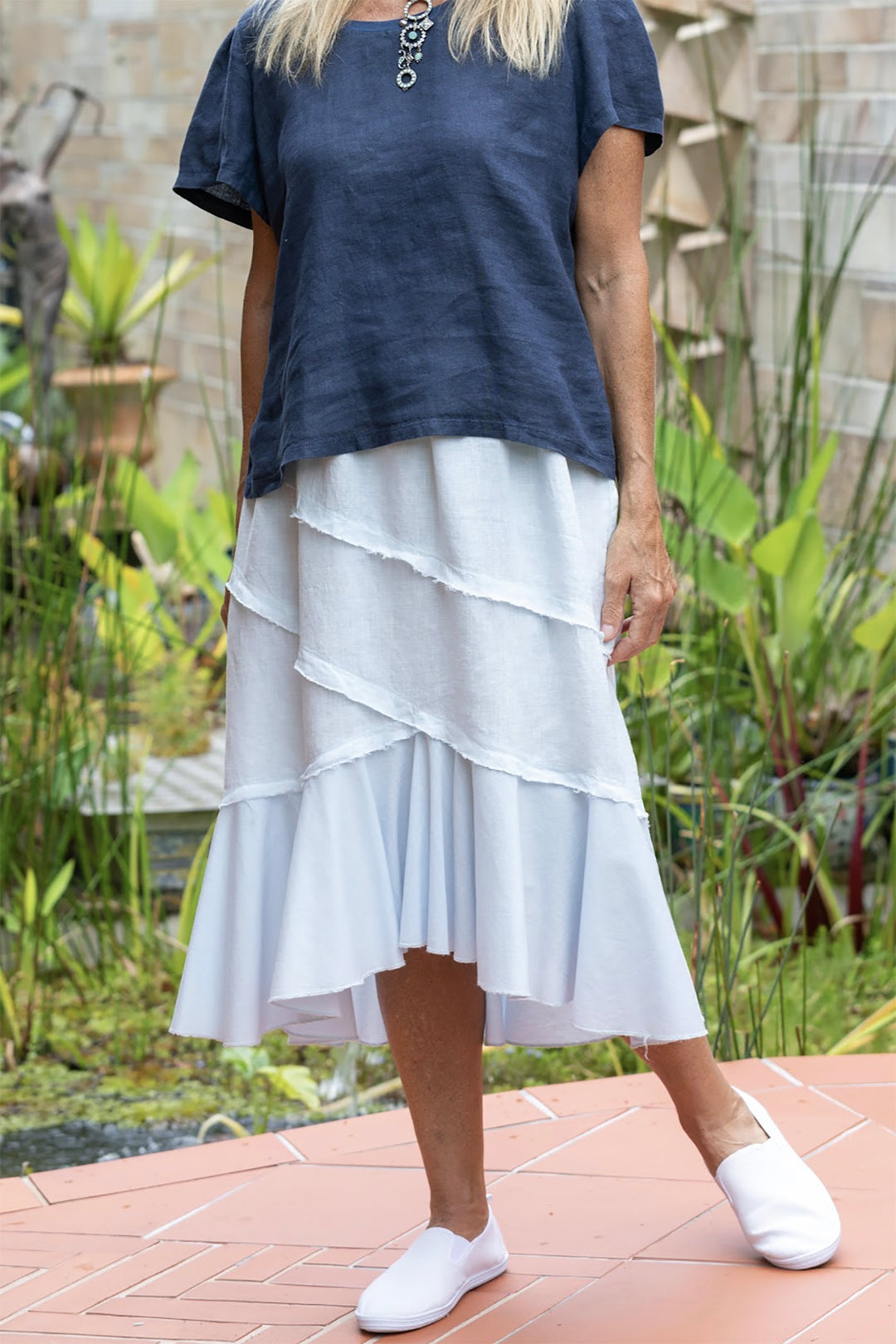 Woman wearing a white skirt by Costa Vita, sold and shipped from Pizazz Boutique Nelson Bay online women's clothes shops Australia
