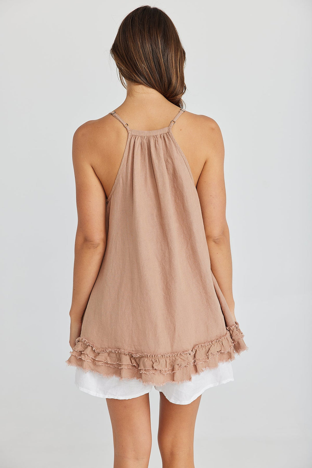 Woman wearing a brown singlet and white shorts by The Shanty Corporation sold and shipped from Pizazz Boutiques Nelson Bay dress shops Australia Back View