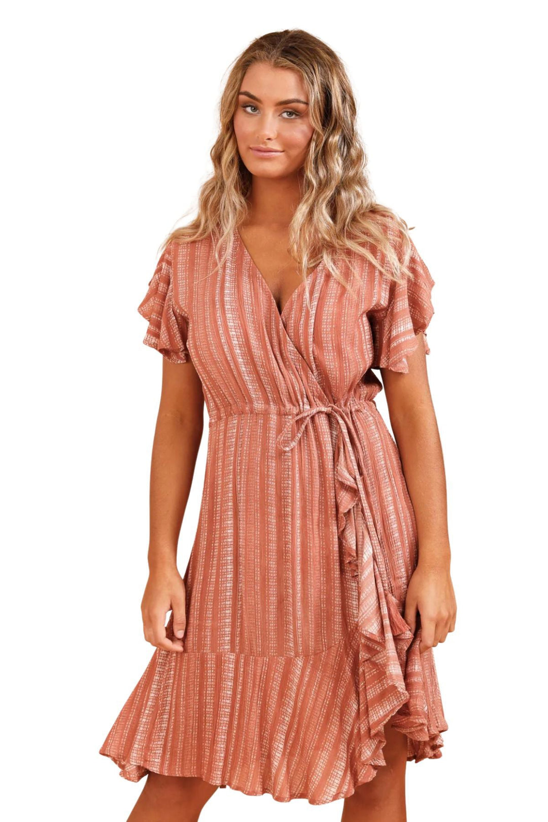 Ladies standing in the Tarot Wrap Dress by Talisman in orange tones, this dress ties up on the side and is knee length. sold by pizazz boutique Nelson Bay NSW.  