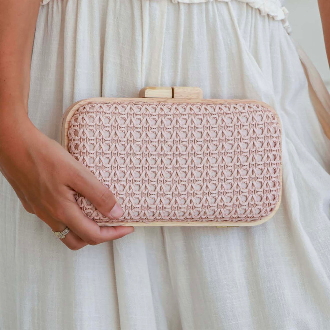 Lady holding Wooden timber clutch, in blush pink, sold and shipped by pizazz boutique Nelson bay Port Stephens. 