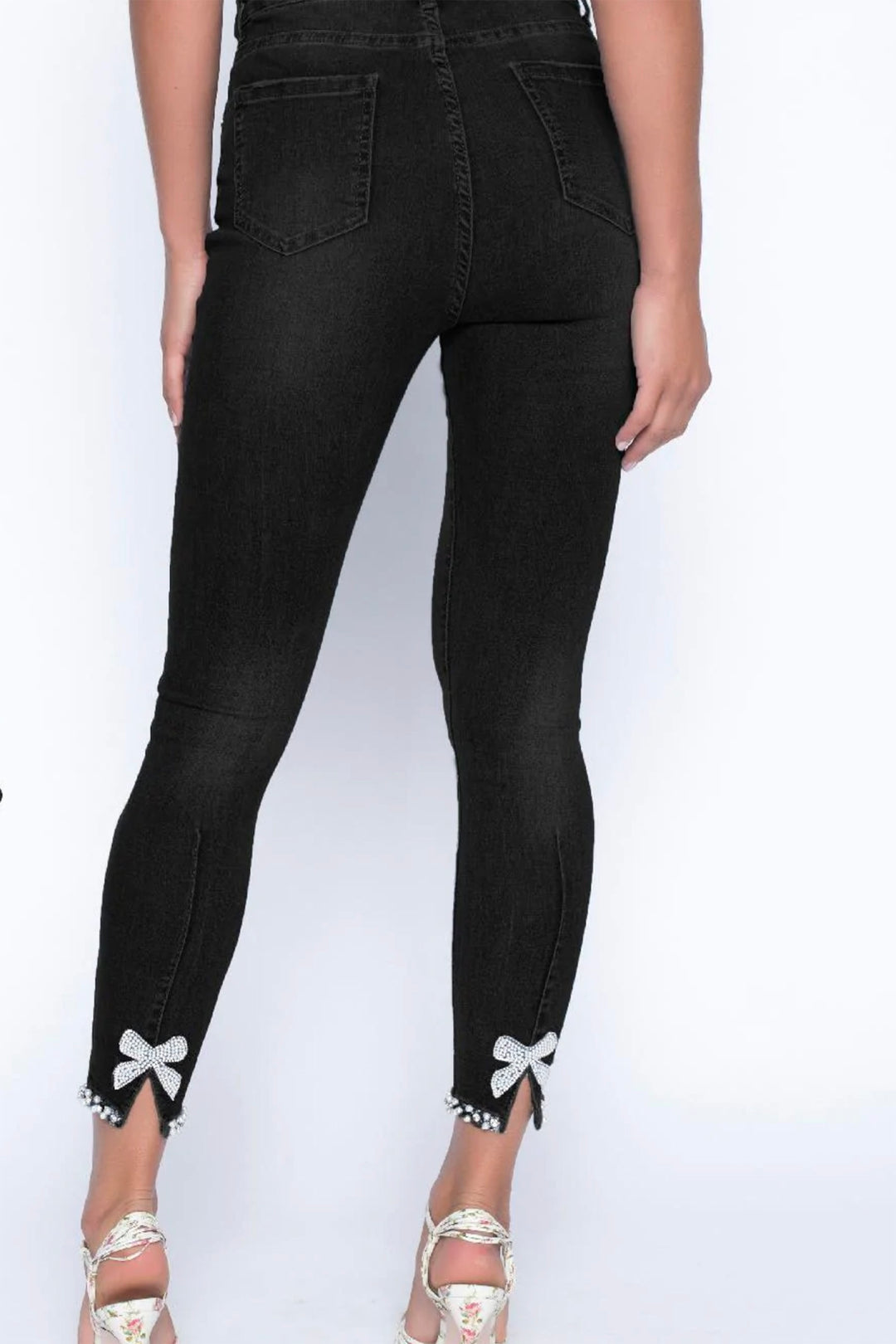 Woman wearing the Bo Pearl Jeans in black by Frank Lyman, sold and shipped from Pizazz Boutique