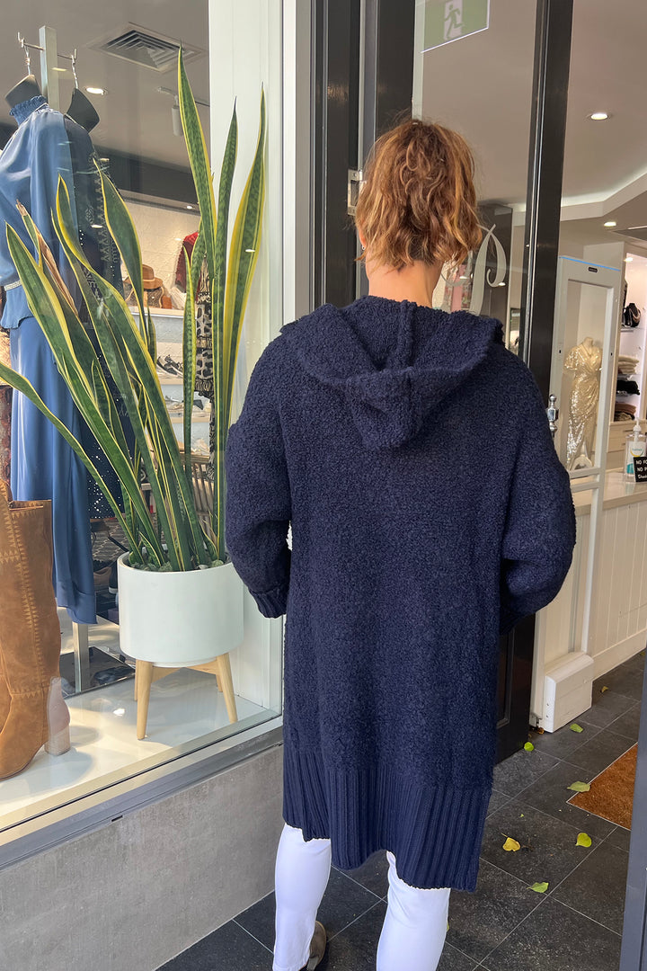 Woman wearing a navy betty bounce cardi by Italian Star, sold and shipped from Pizazz Boutique Nelson Bay women's dresses online Australia back view