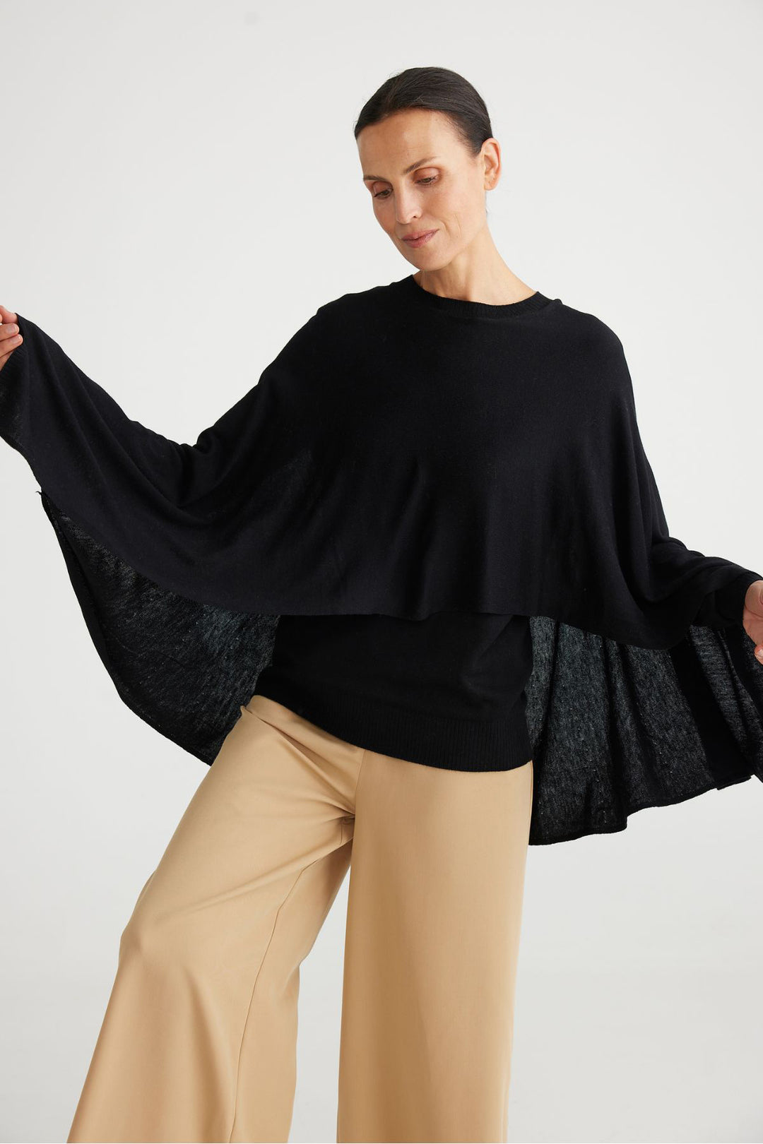With the look of a poncho this long sleeve Juliette Knit by Brave & True is both comfortable and playful. Ultra soft with a layered look, this is a must have knit this season.  Brand : Brave & True Style Code : BT6660-1 Fabric : 54% Polyester 20% Nylon 20% Acrylic 6% Merino Wool Cold hand wash Long sleeve knit with cape poncho style detail Fine knitted soft yarn fabrication Ribbed cuff and hem Round neck Slim fit undergarment 'Every Woman' metallic tag at back neck
