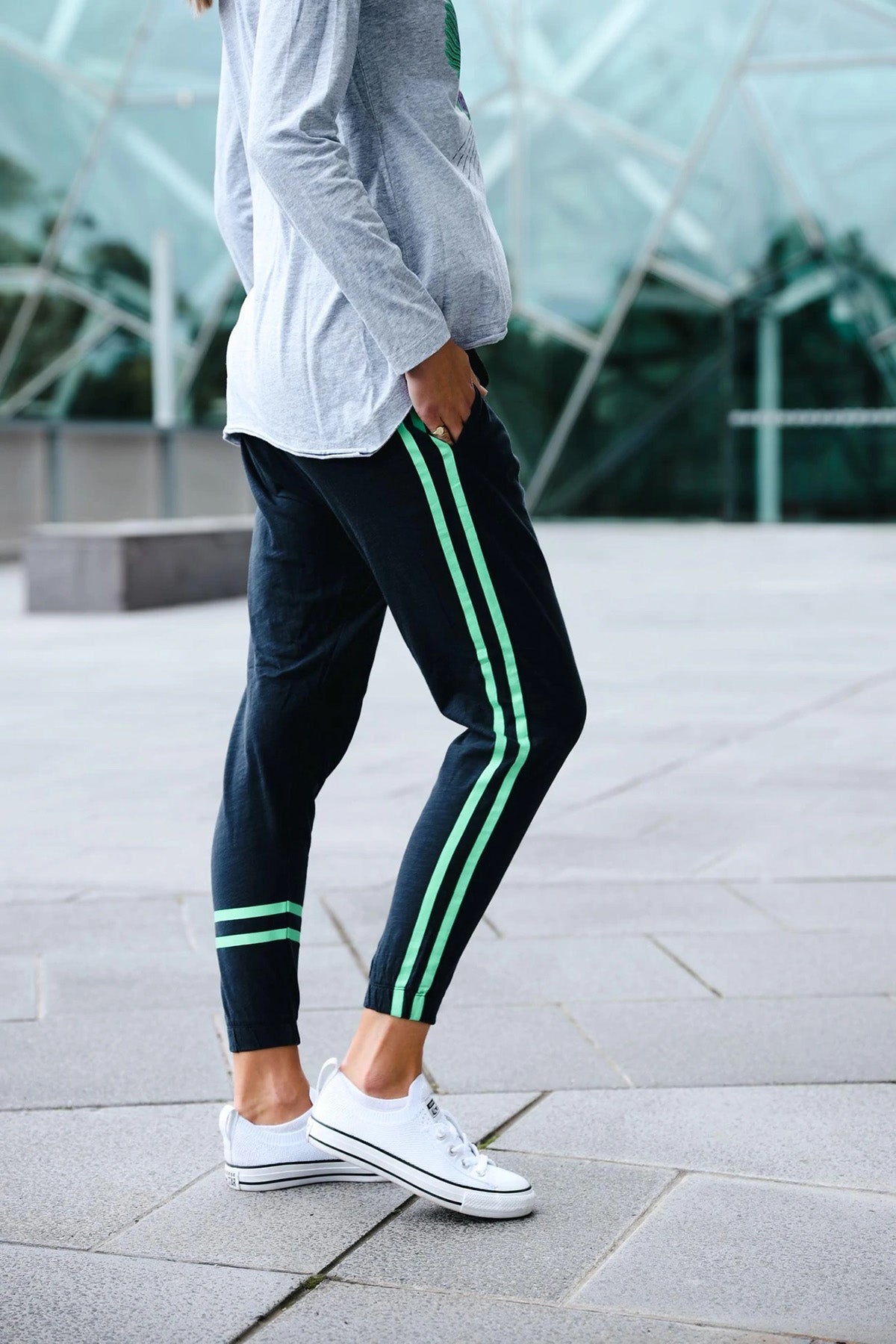 Green joggers with online white stripe